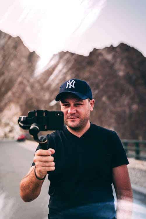 A social media influencer creating content with mountain in the background