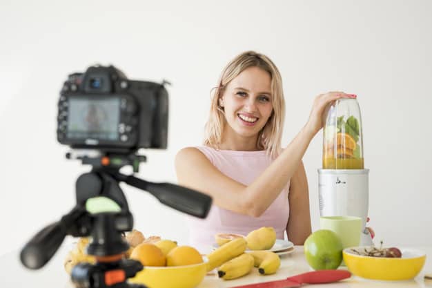 A social media influencer creating content - blending fruit