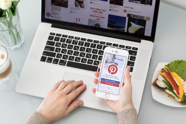 Pinterest login page on mobile and Pinterest pins on laptop