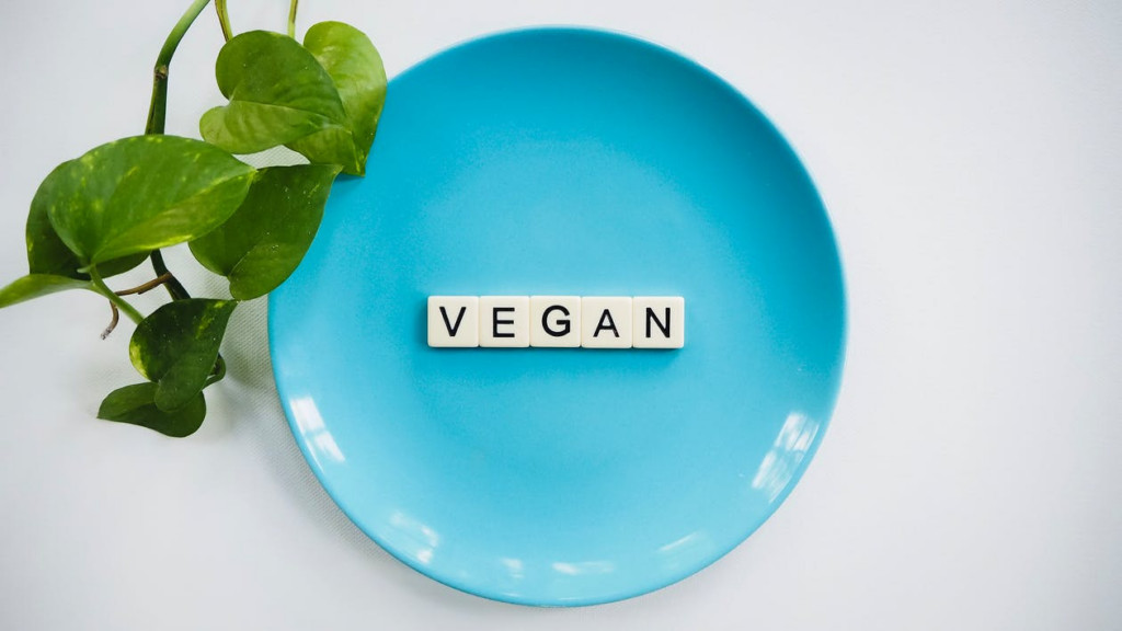 A blue plate with scrabble tiles spelling vegan | Influencer trends