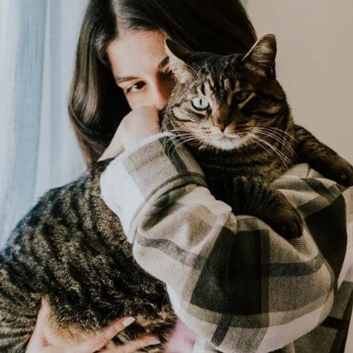 Adriana Reis hugging and cradling her cat