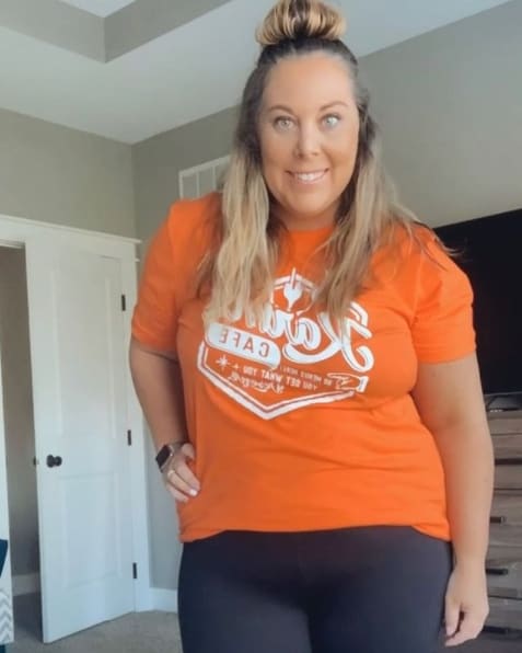 April Lemmon in her orange t-shirt ready to workout
