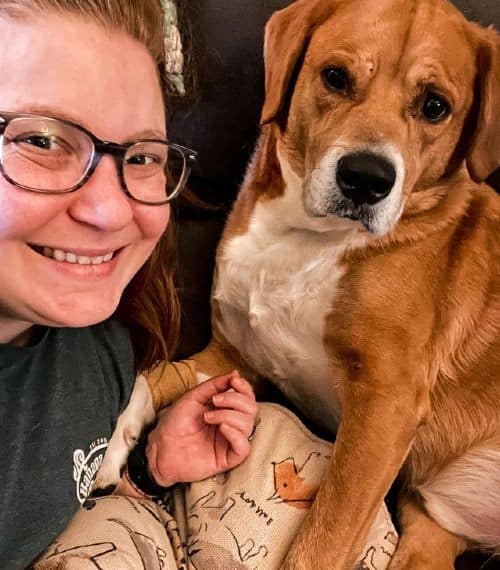 Ashli Ferguson and her pet dog Benny chilling on the sofa