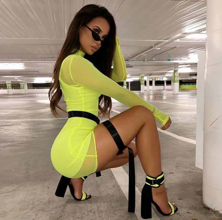 BADASS Clothing Brand | Sexy model in yellow dress squatting in parking lot