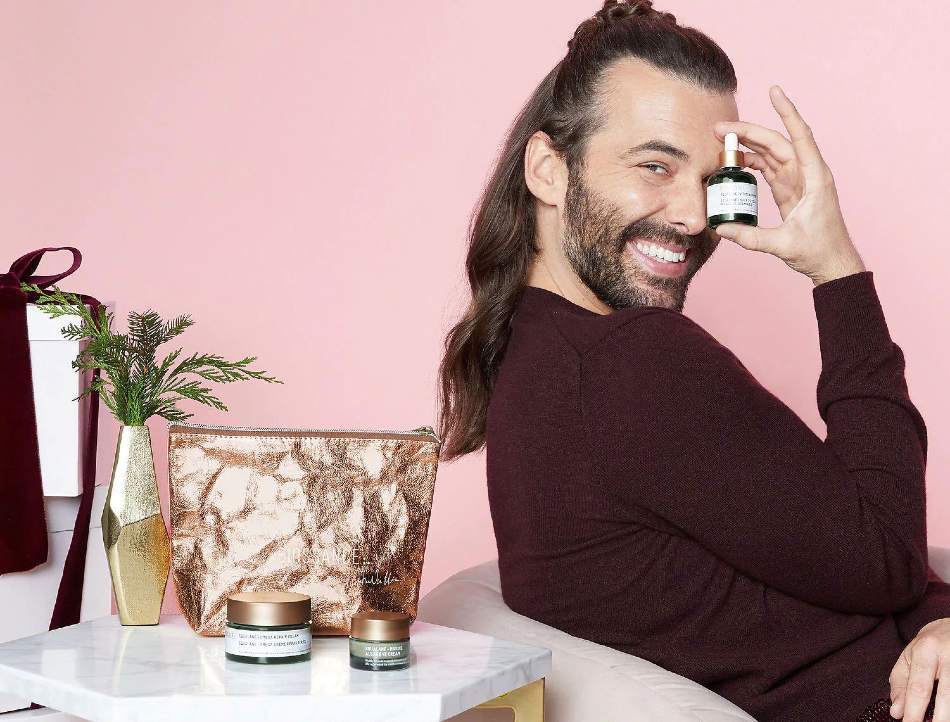 Jonathan Van Ness leaning back on chair while promoting Biossance skincare products | Marketing Success Stories on Afluencer