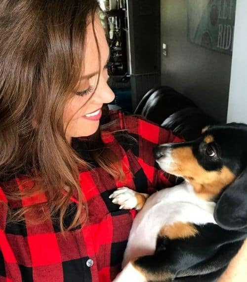 Brandi Carlisle cradling her pet dog Chuck