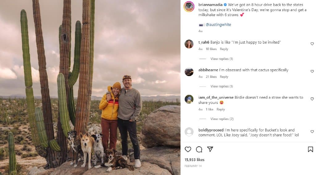 Brianna Madia with her partner and pet dogs posing outdoors next to giant cactus