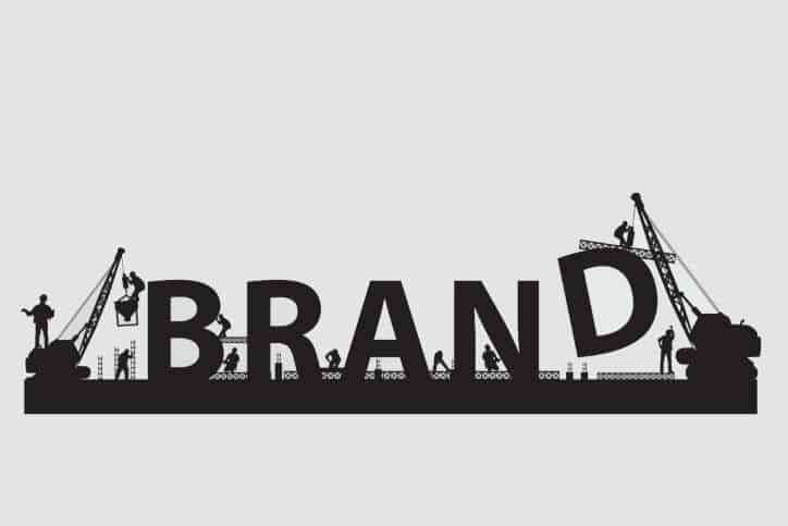 Building a Brand | Construction workers erecting brand lettering















