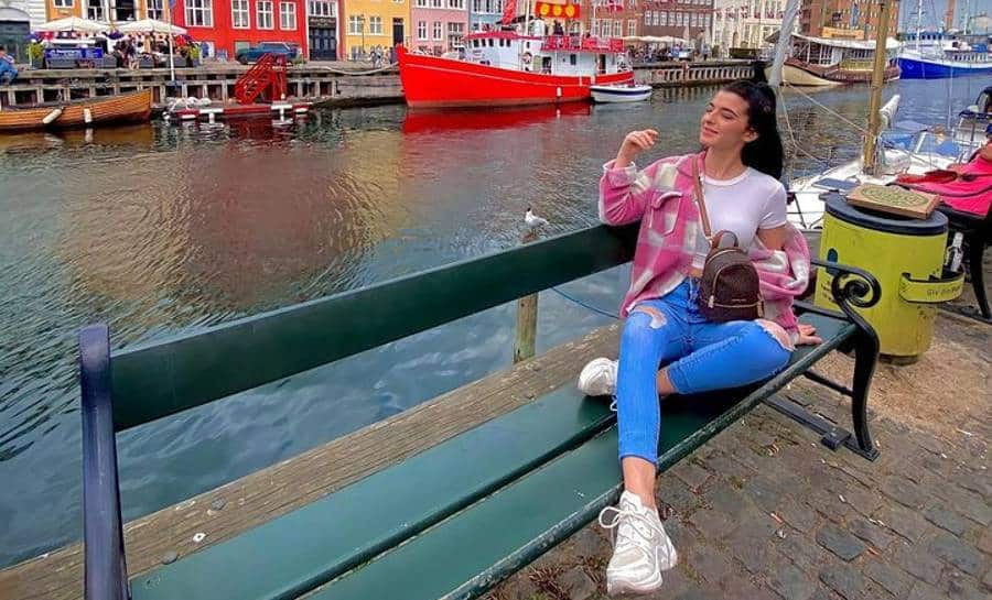 Eila Aragon sitting on a bench in Denmark | Travel micro-influencers