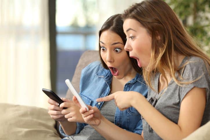 Two women shocked when assessing influencer on their phones