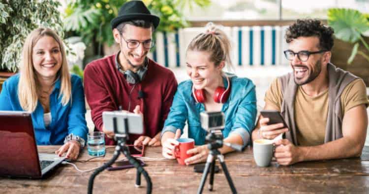 Four influencers sat at a table laughing about their discussion