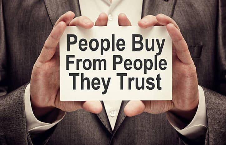 People Buy From People They Trust | man holding card