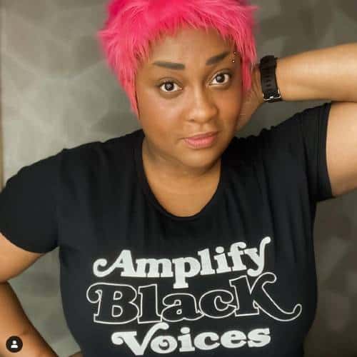 Jamila C with pink hair and Amplify Black Voices t-shirt