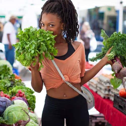 Jenne Claiborne shopping for vegetables at an outdoor market