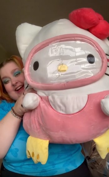 Jojo Lynch with a big stuffed Hello Kitty