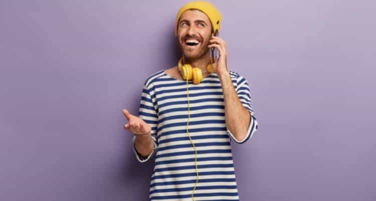 Man in striped t-shirt talking on phone | Influencer Marketing for Shopify Merchants