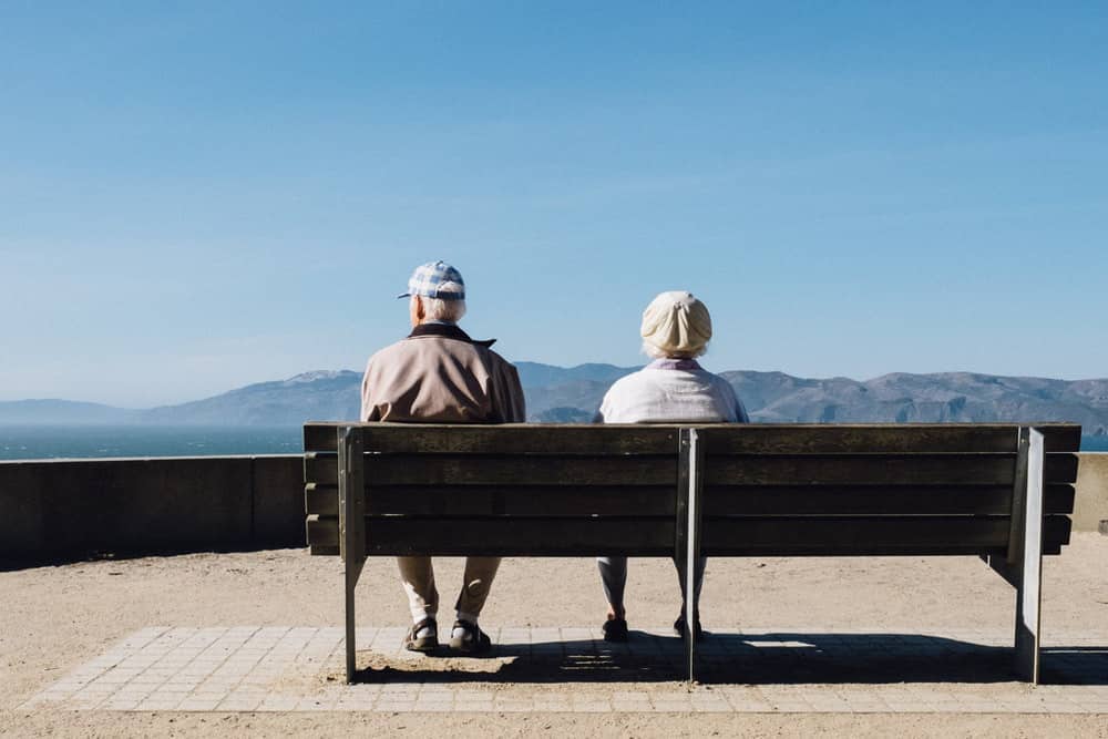 Boomers on a bench looking out at the mountains