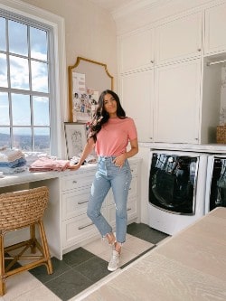Rachel Parcell in jeans pink top in laundry room | Utah fashion bloggers