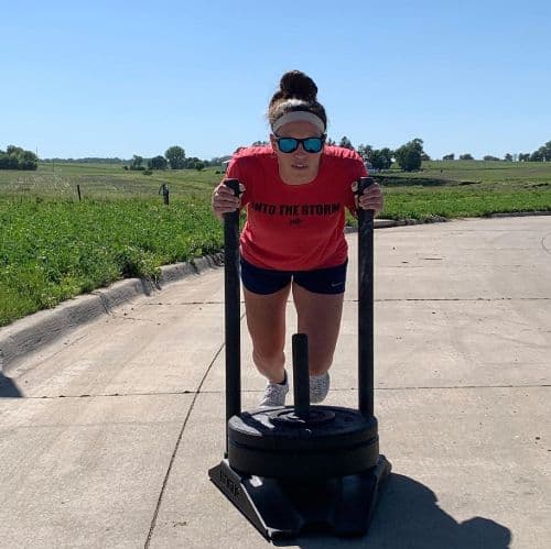 Sarah Lacina working out pushing weights