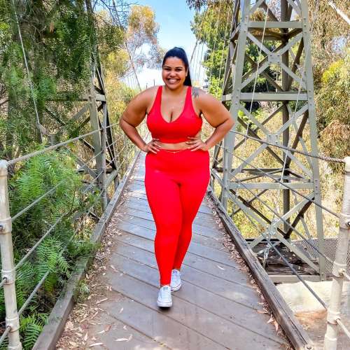 Sondra Jo Holtz posing on a suspension bridge | Author Curves and a Carry On