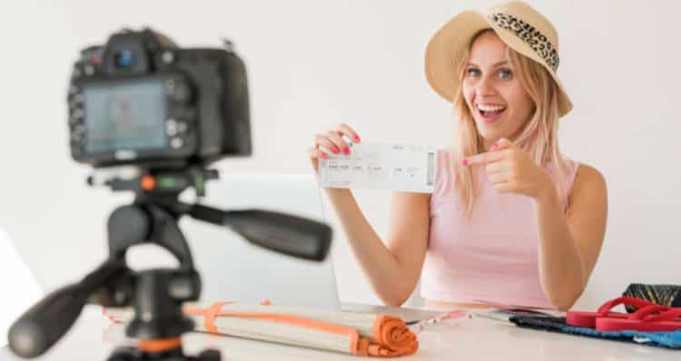 Travel influencer making a video while showing a flight ticket | Influencer Marketing for Shopify Merchants