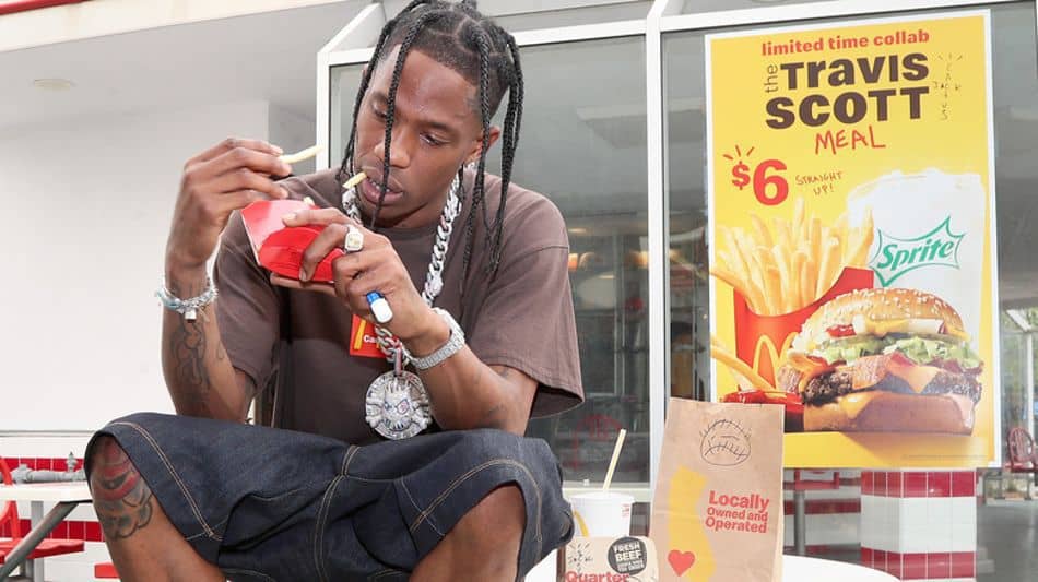 Travis Scott sat outside McDonald's eating fries